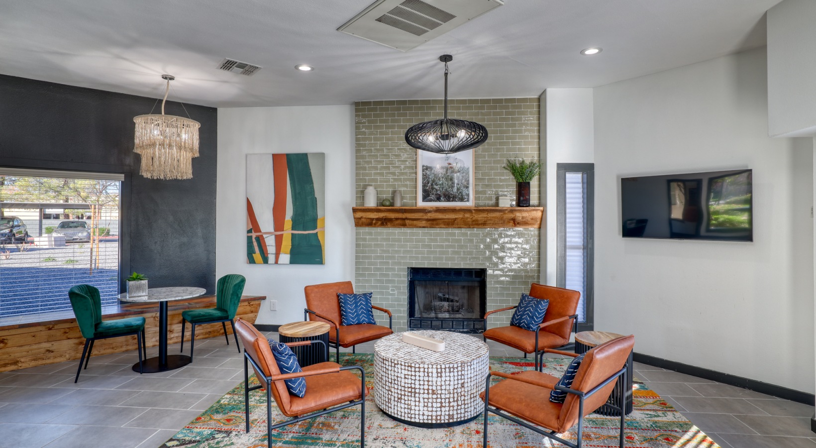 the living room features a fireplace, chairs and a television at The Jerome