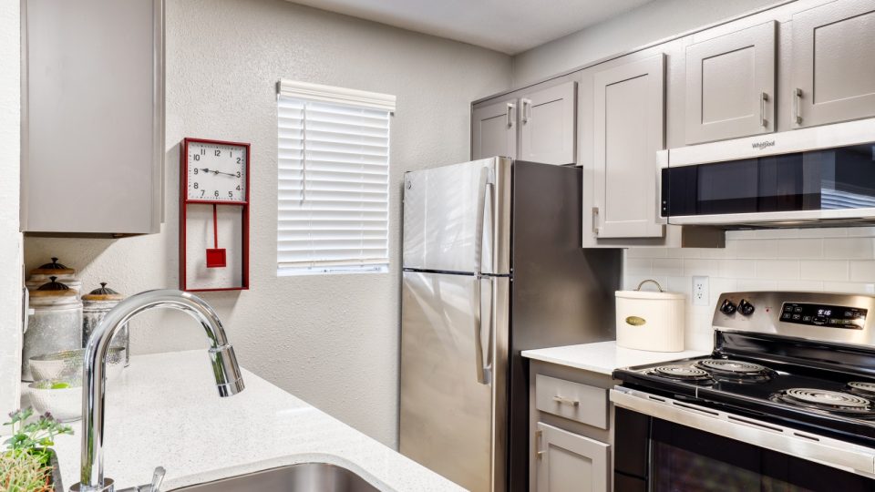 a kitchen with stainless steel appliances and a sink at The Jerome