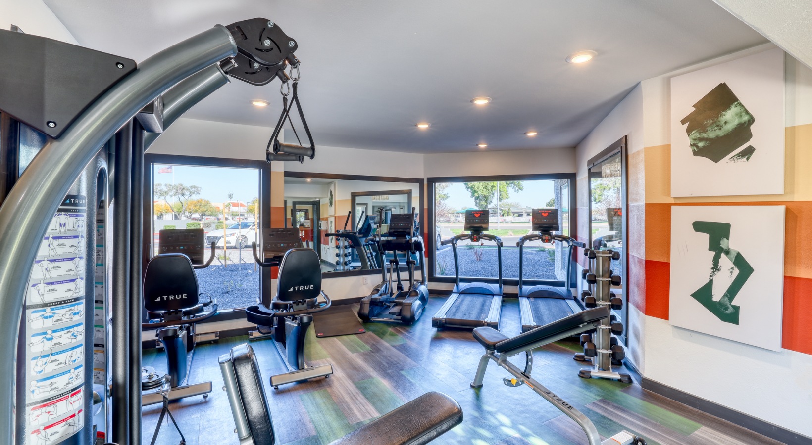 a gym room with exercise equipment and mirrors at The Jerome