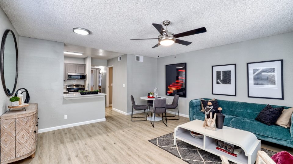 a living room with a ceiling fan and hardwood floors at The Jerome