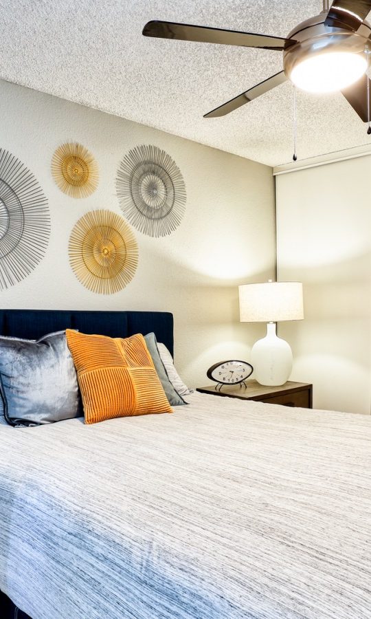 a bedroom with a ceiling fan and a bed at The Jerome